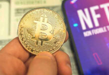 Person holding Bitcoin coin NFT text on screen