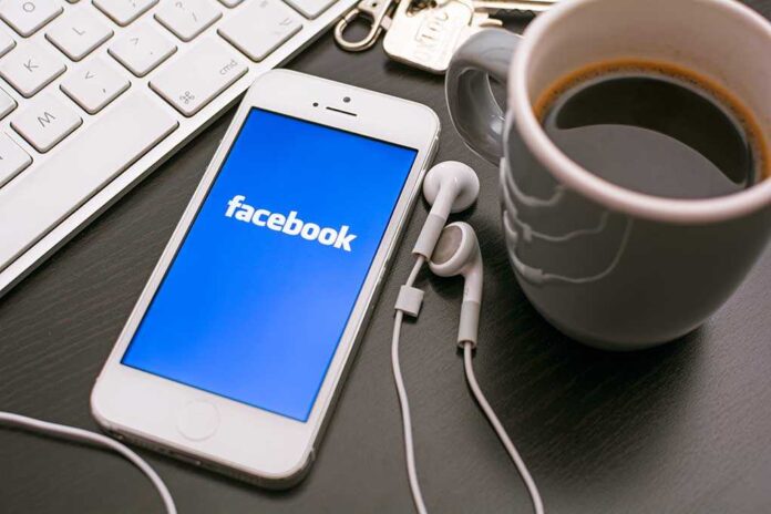 Smartphone displaying Facebook logo next to a cup of coffee and earphones